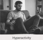 Person sitting on couch with headphones adhd.
