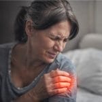 Person experiencing shoulder pain.